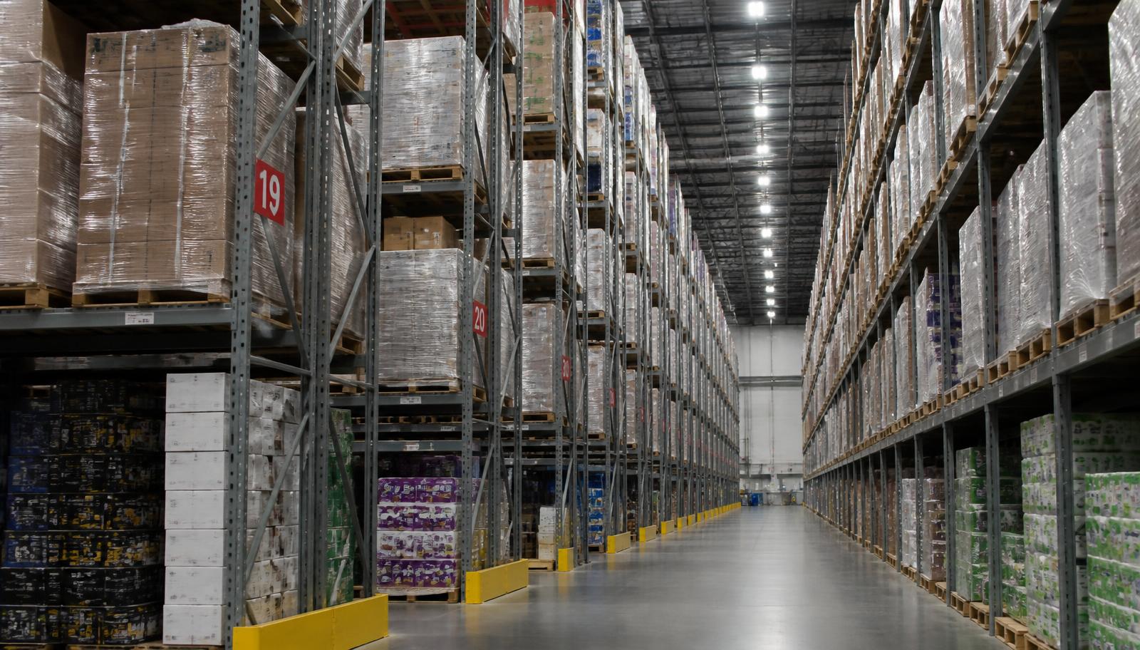 Aisle of tall racking filled with wrapped pallets